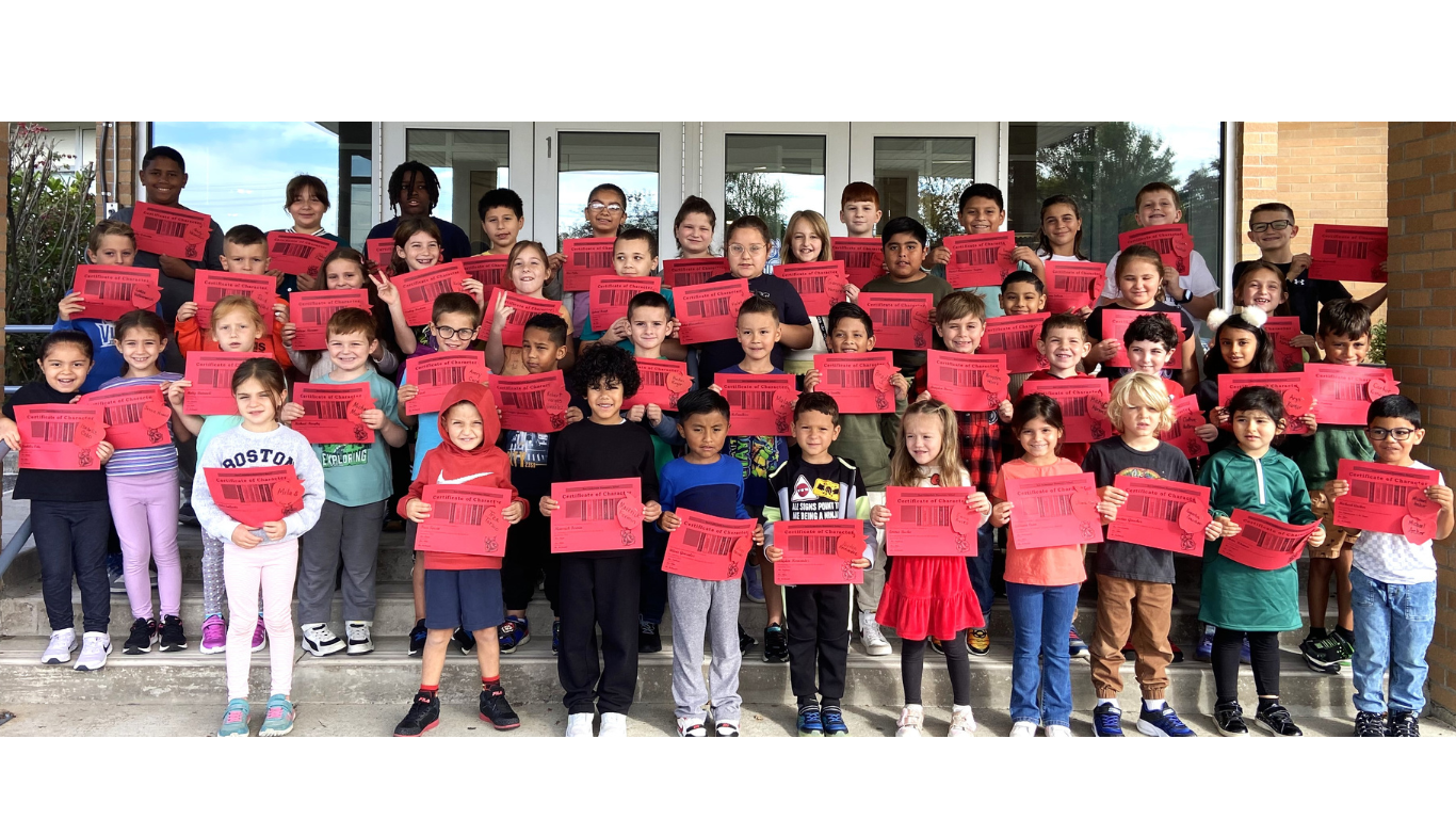 Group of students in front of East Coldenham Elementary School holding red certificates.