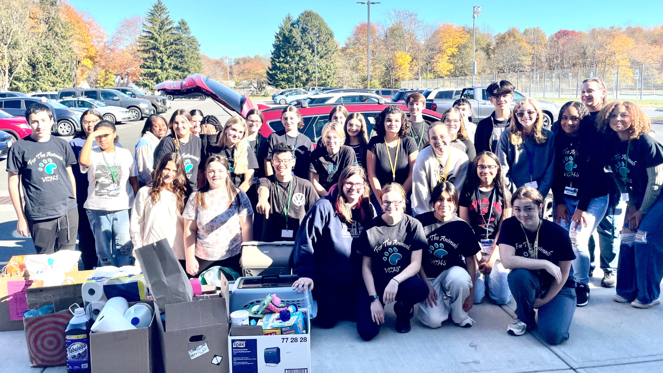 Group of HS students with boxes of donations for the Humane Society