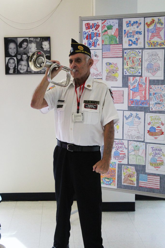 American Legion member Barry Schnipper plays the bugle for fourth graders at East Coldenham Elementary School.