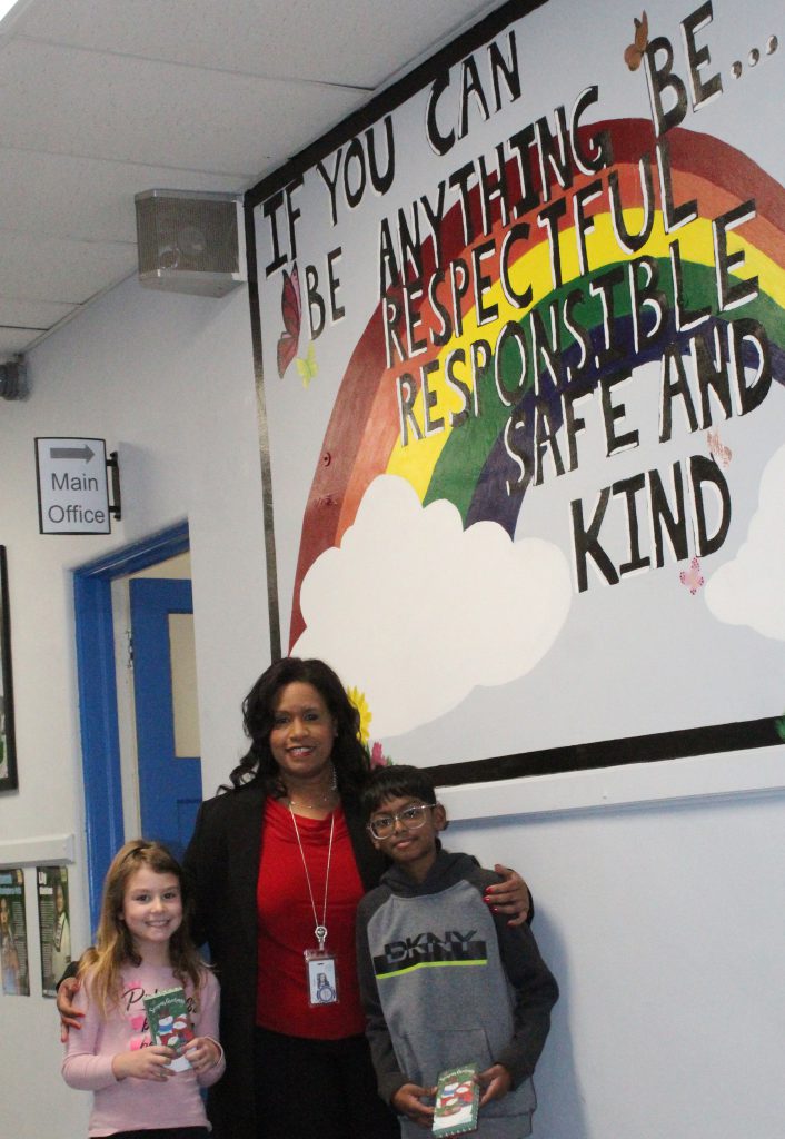 Valley Central School District superintendent Evette Avila presents Emmy Young, a second grader, and Chaten Kumar, a fifth grader at Walden Elementary School with gift certificates for their outstanding selflessness and kindness in saving up their PBIS Viking Bucks to purchase prizes for their siblings.