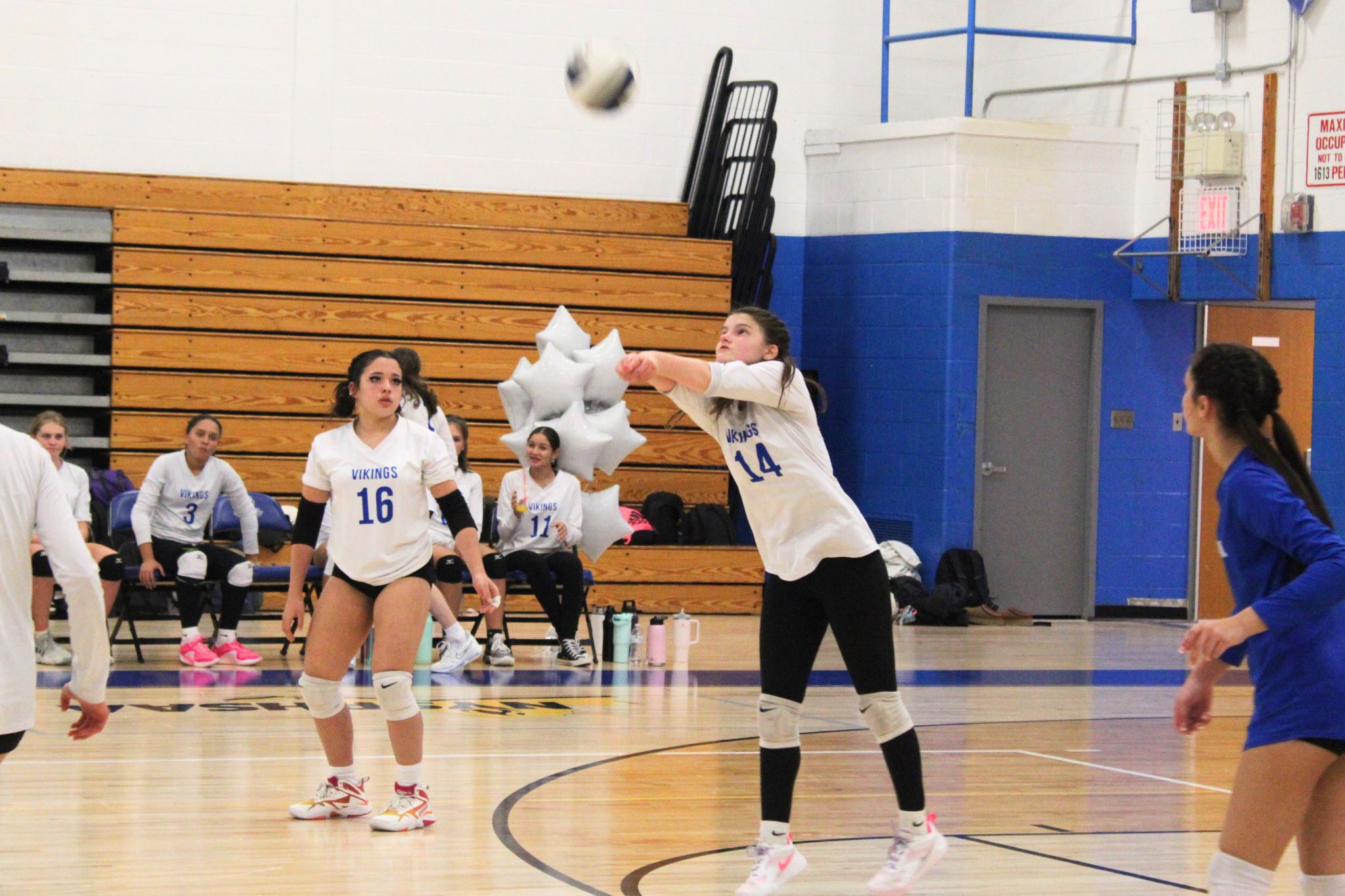 A volleyball player returns a ball in a JV home game. 